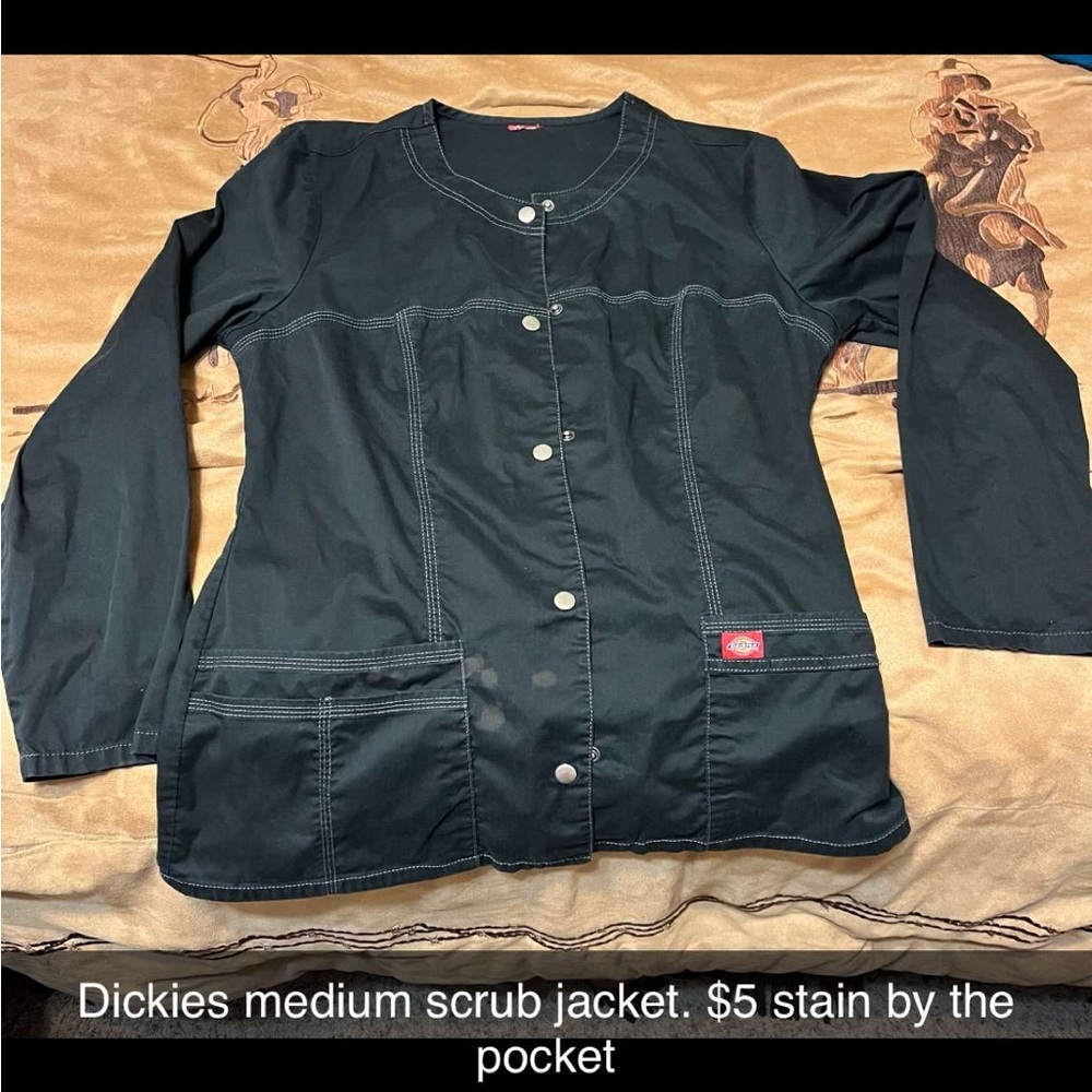 Medium dickies nurse CNA scrub jacket has a stainless stain by the pocket